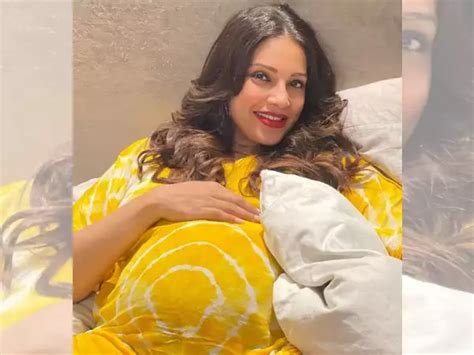 Mom-to-be Bipasha Basu flaunts her baby bump, looks beautiful in a yellow dress. | Filmfare.com