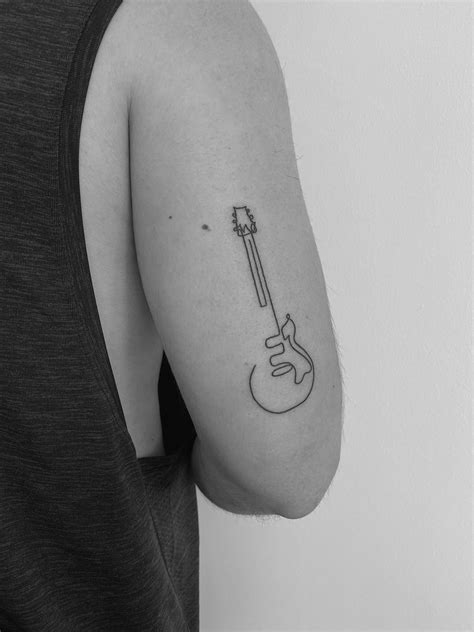 Minimal Guitar Tattoo | Guitar tattoo, Music tattoo designs, Music tattoos