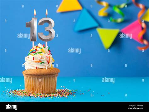 Birthday cake with candle number 13 - Blue background Stock Photo - Alamy