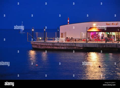 Nightlife in Bar at harbour and pier at evening, capital Ponta Delgada, Island of Sao Miguel ...