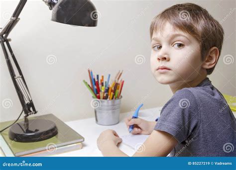 Boy Sitting at the Desk Home and Doing His Homework. Child Writting. School, Children, Education ...