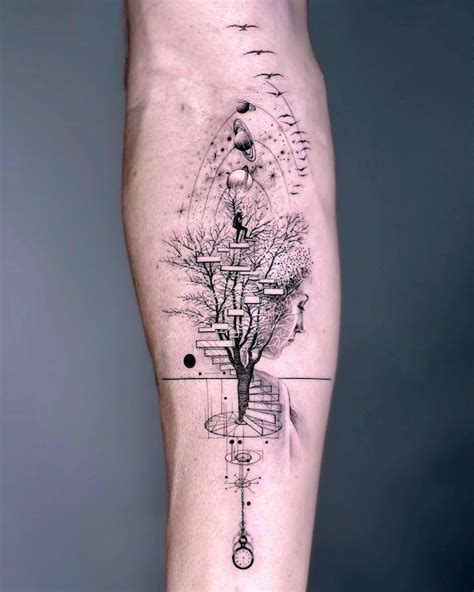 a man's leg with a tree and compass tattoo on it, in black and white