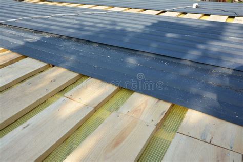 Installing Metal Roof Tiles. Roofing Construction with Metal Roof Sheets Stock Image - Image of ...