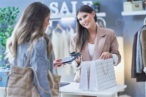 Woman seller and buyer in clothes store 15854215 Stock Photo at Vecteezy