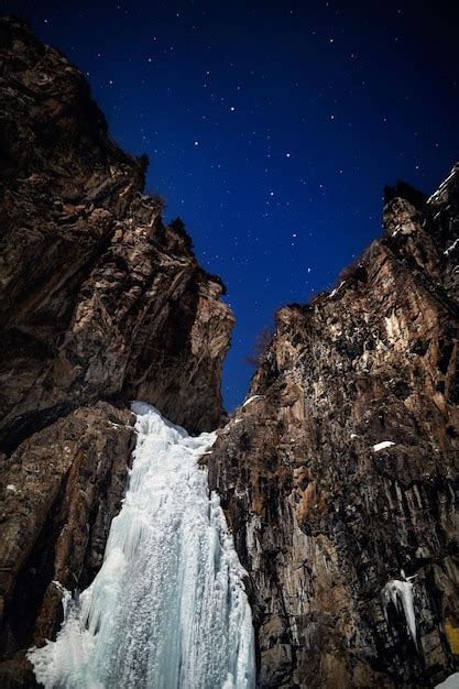 Premium Photo | Frozen waterfall at night starry sky