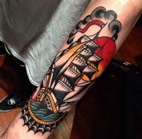 Colorful black ship tattoo on arm