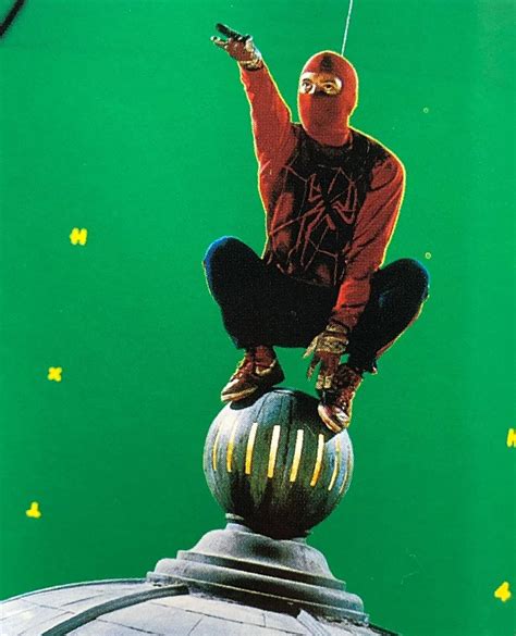 a man in red shirt on top of a metal object with green background and stars