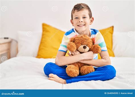 Blond Child Hugging Teddy Bear Sitting on Bed at Bedroom Stock Image ...