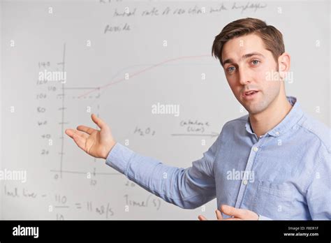 Teacher Standing In Front Of Whiteboard Stock Photo - Alamy