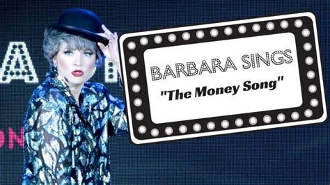 a woman holding up a sign that says barbara sings the money song