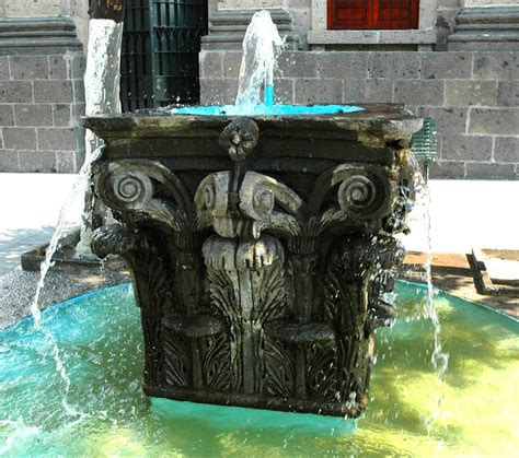 Bright blue and bright turquoise classical stone water fountain, Central square, Guadalajara ...