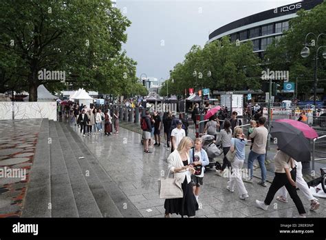 Berlin, Germany. July 29, 2023. Spectators during rain ahead of the Adidas Runners City Night ...