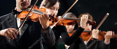 Violin orchestra performing Stock Photo by ©stokkete 47575365