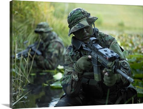 U.S. Navy SEALs cross through a stream during combat operations Wall Art, Canvas Prints, Framed ...