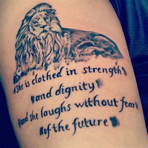 a tattoo with an image of a lion and the words she is clothed in strength