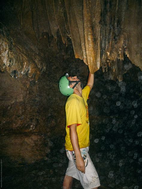 «Young Adventurer Man Doing Speleology On A Cave Looking Stalactite ...