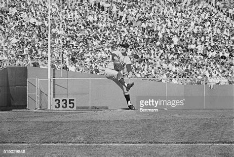 Ed "Whitey" Ford of the New York Yankees pitching during their first ...