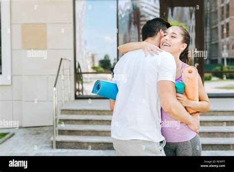 Pleasant joyful people hugging each other Stock Photo - Alamy