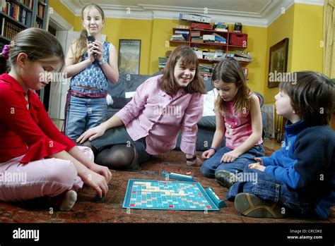 Family at home playing Scrabble board game, United Kingdom Stock Photo - Alamy