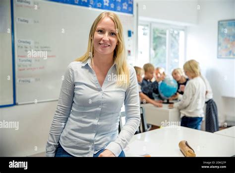 Teacher standing in classroom Stock Photo - Alamy