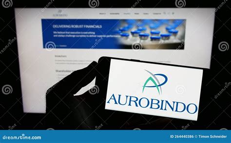 Person Holding Mobile Phone with Logo of Indian Company Aurobindo Pharma Limited on Screen in ...