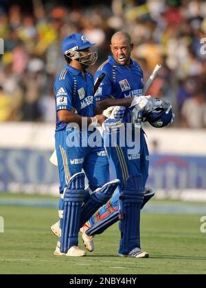 Mumbai Indians batsmen Rohit Sharma, left, and Andrew Symonds adjust ...