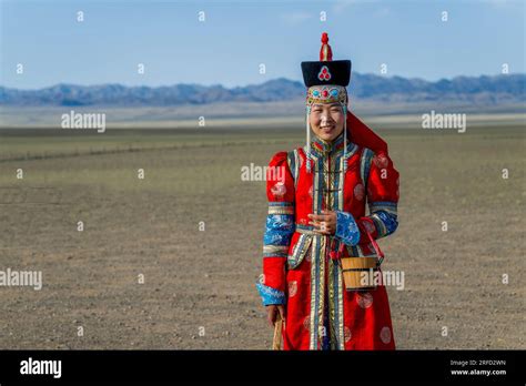 A Mongolian young woman in traditional dress at the Gobi Mirage lodge in the Gobi Desert ...