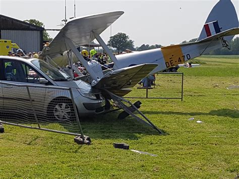 Spectator taken to hospital after Tiger Moth biplane crashes near ...