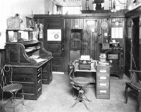 an old fashioned office with many desks and chairs in the room ...