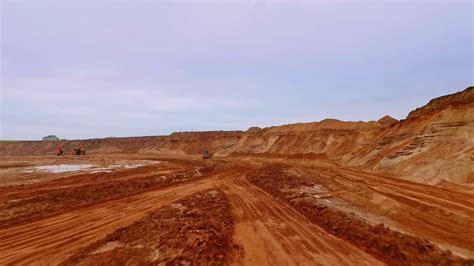 Mining industry. Aerial view of road to industrial territory sand mine. Crawler excavator sand ...