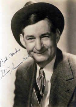 an old black and white photo of a man in a suit with a hat on