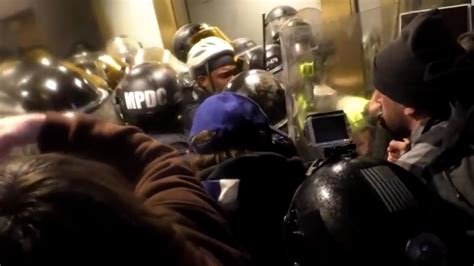 New Capitol riot videos show mob battling officers in tunnel - CNN Video