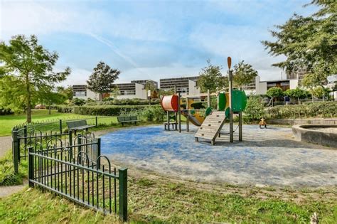 Premium Photo | A playground in a park with buildings in the background