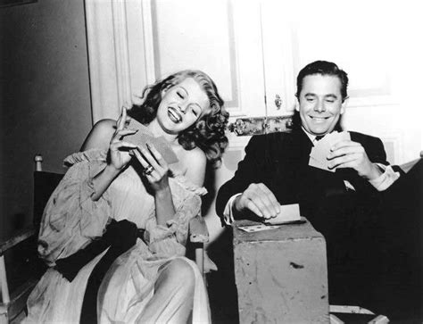 Old Hollywood Films, Rita Hayworth and Glenn Ford play cards on the set...