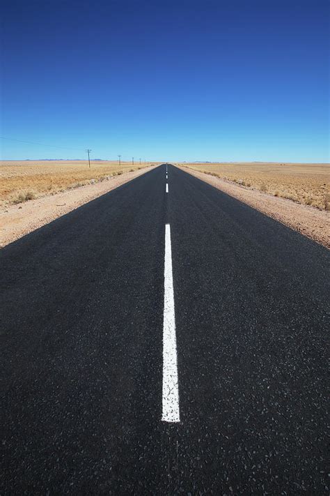 White Line On A Paved Road In The Desert Photograph by Lars Froelich / Design Pics