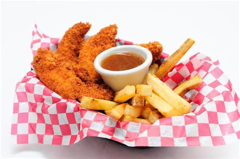 Premium Photo | Breaded chicken strips with french fries and dipping ...