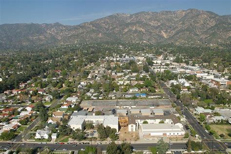 an aerial view of a city with mountains in the background