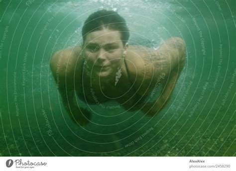 Woman diving underwater - a Royalty Free Stock Photo from Photocase