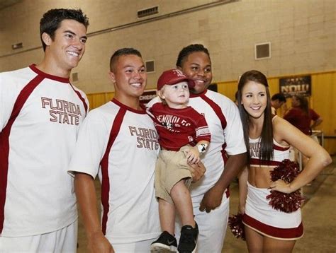 A young fan gets a photo taken with some of the FSU Cheerleaders on ...