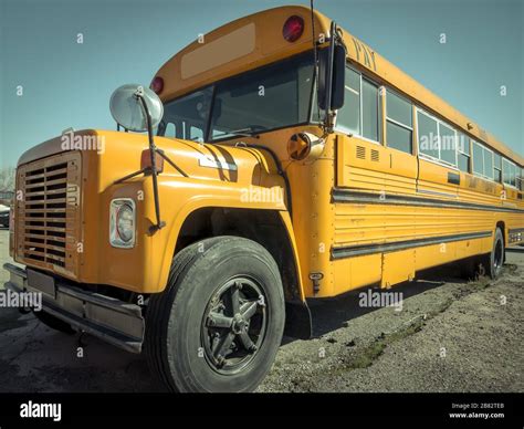 Parked vintage yellow school bus Stock Photo - Alamy