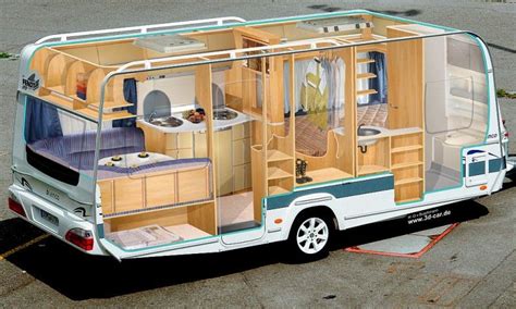 an rv is parked in a parking lot with its doors open and the kitchen inside