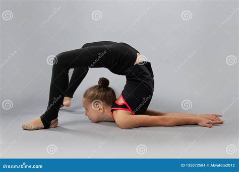 Attractive Girl Gymnast Performs a Complex Exercise. Flexibility, Stretching Stock Photo - Image ...