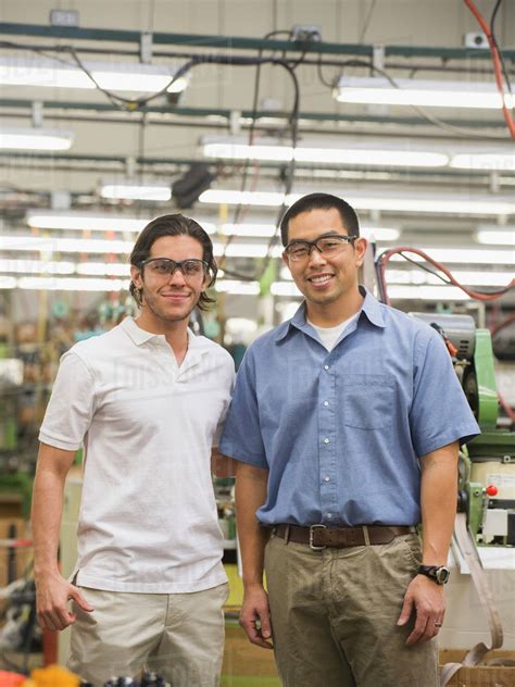 Workers smiling in textile factory - Stock Photo - Dissolve