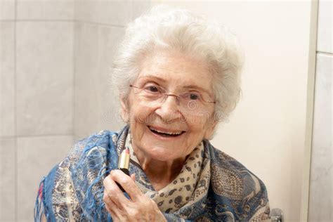 Elderly Lady Applying Lipstick Stock Photo - Image of face, life: 242423496