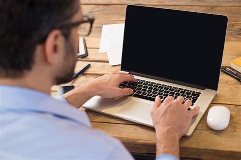 Premium Photo | Back view of businessman sitting in front of laptop screen. man typing on a ...