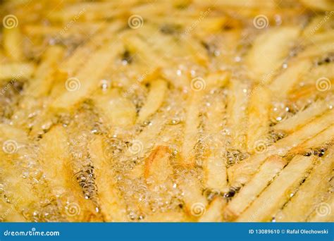 Frying french fries in oil stock photo. Image of fring - 13089610