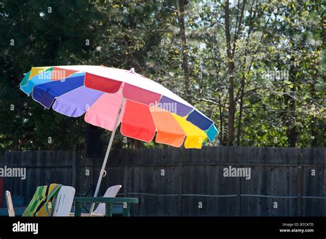 Colorful umbrella providing shade by the pool Stock Photo - Alamy