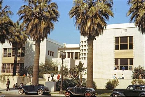 Color photo of mid-1930s automobiles parked out front of Hollywood High School on Sunset Blvd ...