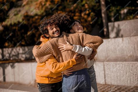 Premium Photo | Happy. Young people feeling joyful and hugging in the ...