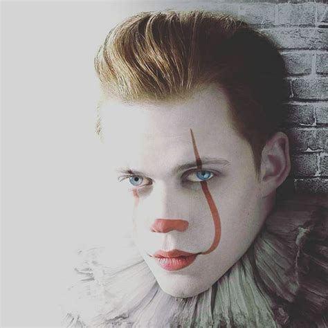 a man with clown makeup on his face next to a brick wall